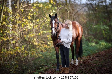 Young Woman With Horse In Full Body Portraits In Sunshine In Autumn Forest.
