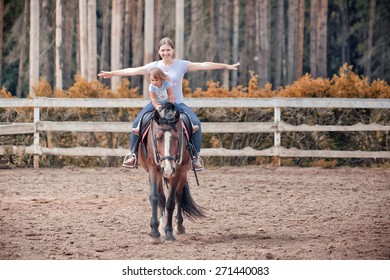 The young woman horseback riding at summer evening - Powered by Shutterstock