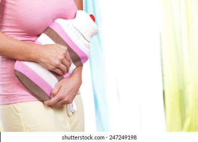 Young Woman With Hot Bottle And Bladder Infection