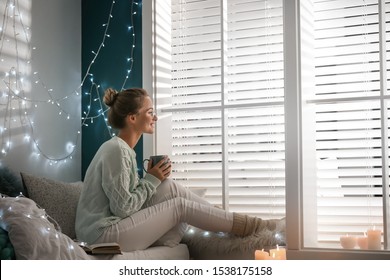 Young Woman With Hot Drink At Home. Cozy Winter