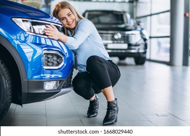 Young Woman Hugging A Car In A C Ar Showroom