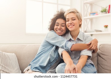 Young woman hugging her friend at home. Friends spending time together, care, friendship, fun concept, copy space