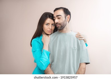 Young Woman Hugging Man, Showing Love, Care, Looking At Camera. Mixed Race, Brown Hair. Attractive People, Closeup Portrait. Studio Shot, Commercial, Advertising Concept