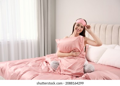 Young Woman Hugging Pillow On Comfortable Bed With Silky Linens