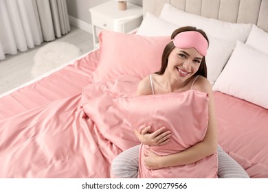 Young Woman Hugging Pillow On Comfortable Bed With Silky Linens