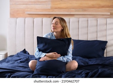 Young Woman Hugging Pillow On Comfortable Bed With Silky Linens