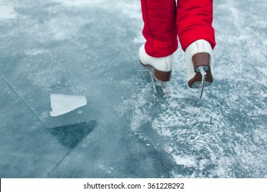 Young woman ice skating outdoors on a pond on a freezing winter day - detail of the legs - Shutterstock ID 361228292