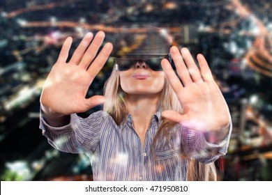 Young Woman Immersed In Interactive Virtual Reality Video Game Doing Gestures On Black Background.