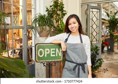 Young woman as an independent florist at the opening of garden center - Powered by Shutterstock