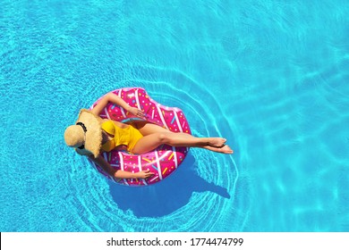 Young Woman With Inflatable Ring In Swimming Pool, Top View