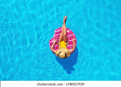 Young Woman With Inflatable Ring In Swimming Pool, Top View