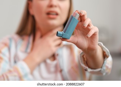 Young Woman With Inhaler Having Asthma Attack At Home