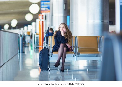 Young Woman In International Airport, Waiting For Her Flight And Looking Upset Or Worried. Missed, Canceled Or Delayed Flight Concept