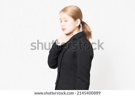 A young woman in a jacket with a sore throat