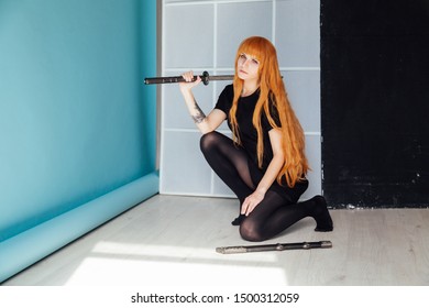 Young Woman In Japanese Anime Cosplay, Holding Samurai Sword.