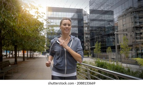 young woman jogging in a modern city - Powered by Shutterstock