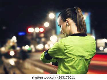 Young Woman Jogging At Night In The City