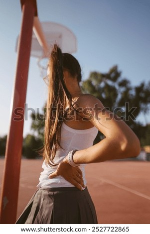 Similar – Young woman stretching legs before training outdoors