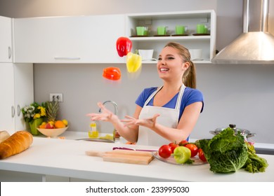 Young Woman  Juggle With Vegetables In Kitchen