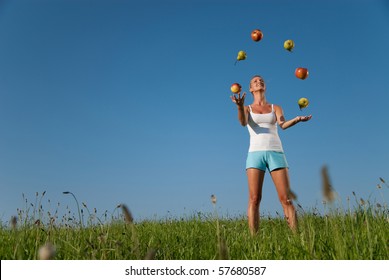 Young Woman Juggling With Healthy Eating