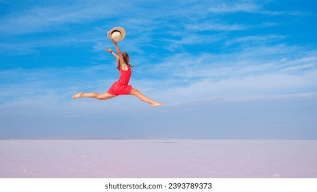 Young woman jumping in the air on Dead sea, salt shore, salt lake on blue sky - Powered by Shutterstock