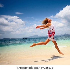 Young Woman Jumping On A Beach