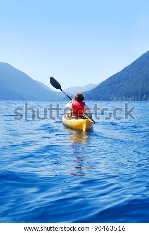 Young woman kayaking on Lake Crescent, Olympic National Park, Washington, USA