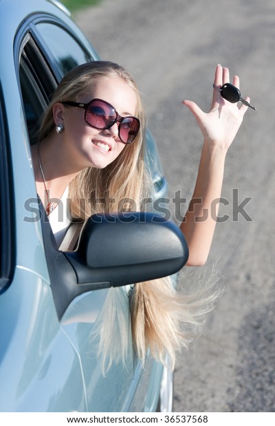young woman with keys of the\
car