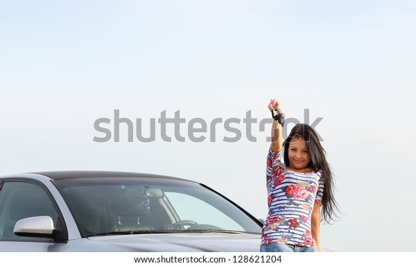 young woman with keys in\
hand, the car