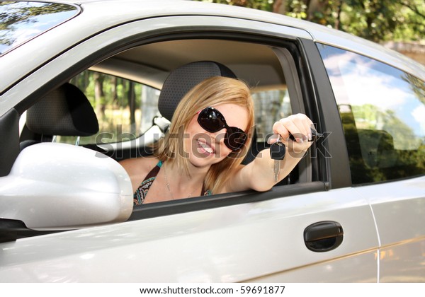 young woman with keys to new\
car