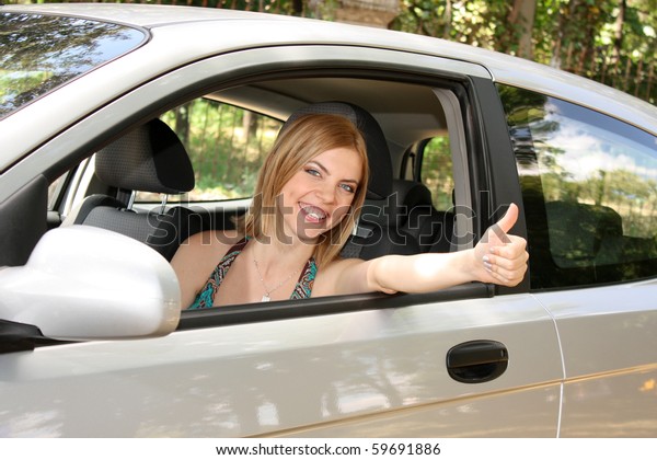 young woman with keys to new\
car