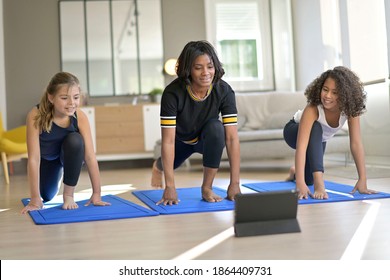 Young Woman With Kids Doing Fitness Exercices At Home, Online Class