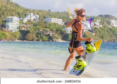 A Young Woman Kite-surfer Ready For Kite Surfing Rides In Blue Sea