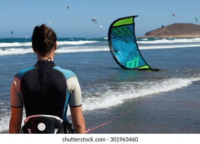 A Young Woman Kitesurfer Ready For Kite Surfing Rides In Blue Sea