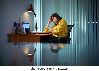 Young Woman With Laptop Computer For Homework. Tired Hispanic Girl And College Education. Female Student Studying And Using Pc At Home Getting Headache