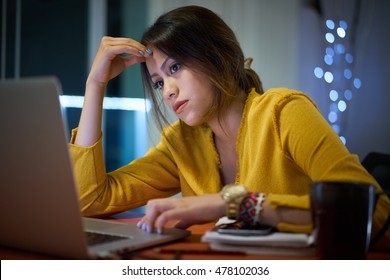 Young Woman With Laptop Computer For Homework. Tired Hispanic Girl And College Education. Female Student Studying And Using Pc At Home Getting Headache