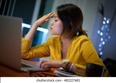 Young Woman With Laptop Computer For Homework. Tired Hispanic Girl And College Education. Female Student Studying And Using Pc At Home Getting Headache