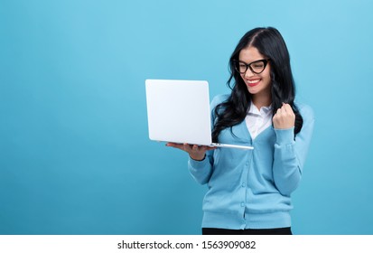 Young Woman With A Laptop Computer With Successful Pose