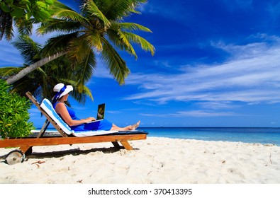 Young Woman With Laptop On Tropical Beach