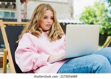 A Young Woman With A Laptop. Outdoor Cafe, Freelance Work