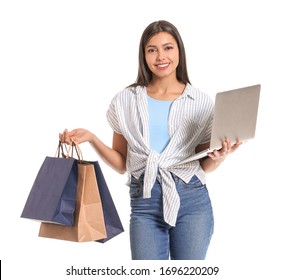 Young Woman With Laptop And Shopping Bags On White Background