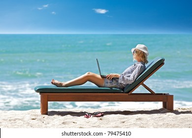 Young Woman With Laptop At The Tropical Beach