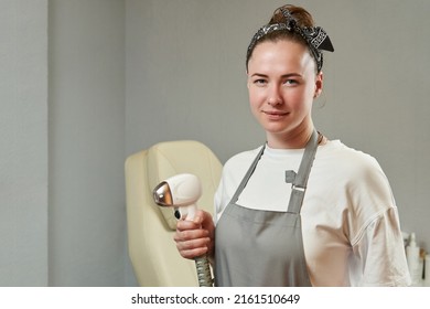 Young Woman With A Laser Device Maniple. Copyspace