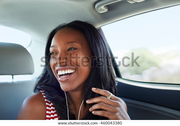Young woman laughing car\
backseat