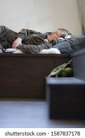 Young Woman Laying Down Wearing Headphones