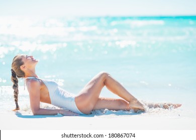 Young Woman Laying On Beach