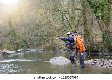 Young Woman Learning To Fly Fishing With A Guide