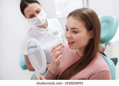 Young Woman Learning Using Interdental Toothbrush At Dentists Office