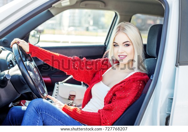 A young woman learns to drive a car. Concept trip,\
lifestyle, driver, auto.