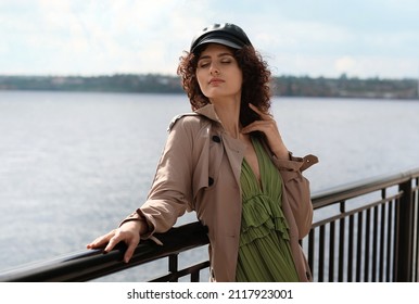Young woman in leather cap enjoining sunny day outdoors - Shutterstock ID 2117923001
